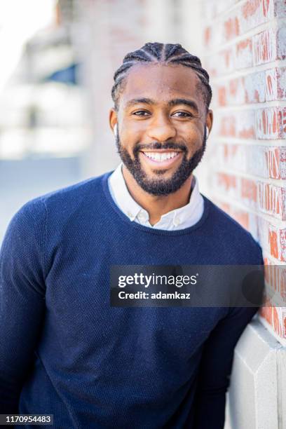 handsome young black businessman with wearable technology - african cornrow braids stock pictures, royalty-free photos & images