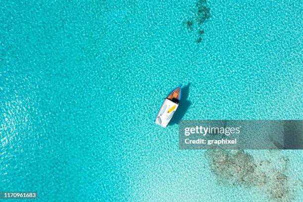 aerial view of boat in ocean - maldives boat stock pictures, royalty-free photos & images