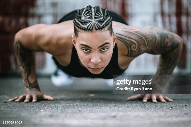 strong and fit woman working out in gym - tough tattoos stock pictures, royalty-free photos & images
