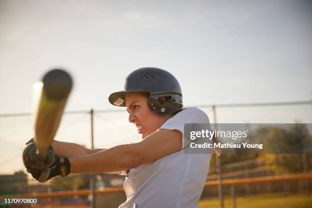 Woman swings baseball bat