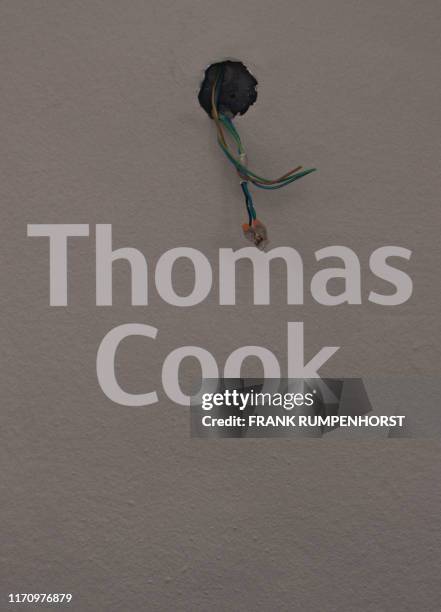 Pulled out cable is seen in a travel agency at the headquarters of the German arm of bankrupt British tour operator Thomas Cook in Oberursel near...