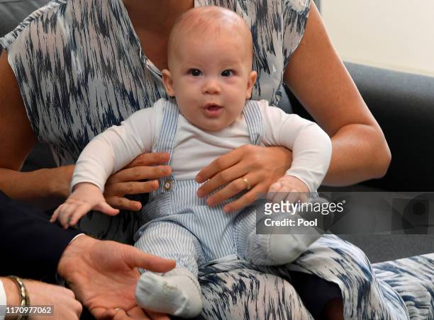 Meghan, Duchess of Sussex holds her baby son Archie Mountbatten-Windsor as they meet Archbishop Desmond Tutu at the Desmond & Leah Tutu Legacy...