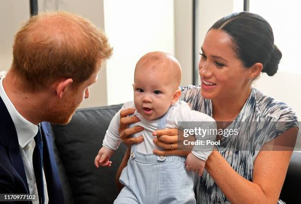 Prince Harry, Duke of Sussex and Meghan, Duchess of Sussex tend to their baby son Archie Mountbatten-Windsor at a meeting with Archbishop Desmond...