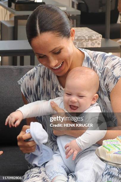 Britain's Duchess of Sussex Meghan hold their baby son Archie as she and the Duke meet with Archbishop Desmond Tutu and his wife at the Tutu Legacy...