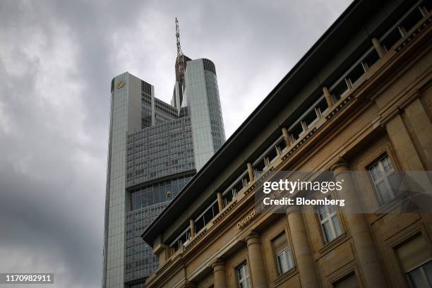 The Commerzbank AG headquarters towers over a Deutsche Bank AG bank branch in Frankfurt, Germany, on Tuesday, Sept. 24, 2019. European banks started...