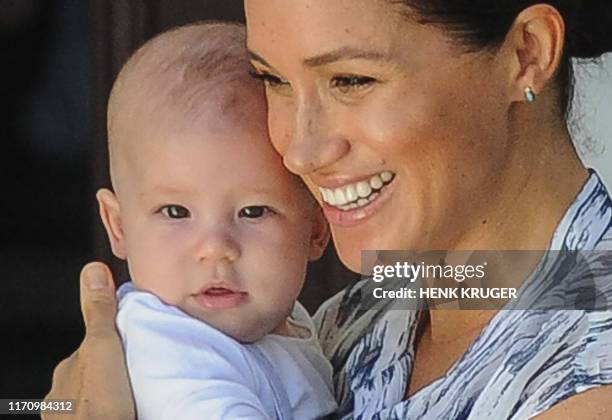 Meghan, Duchess of Sussex holds her baby son Archie as she and Britain's Prince Harry, Duke of Sussex meet Archbishop Desmond Tutu and his wife Leah...