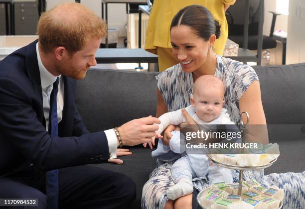Britain's Duke and Duchess of Sussex, Prince Harry and his wife Meghan hold their baby son Archie as they meet with Archbishop Desmond Tutu at the...