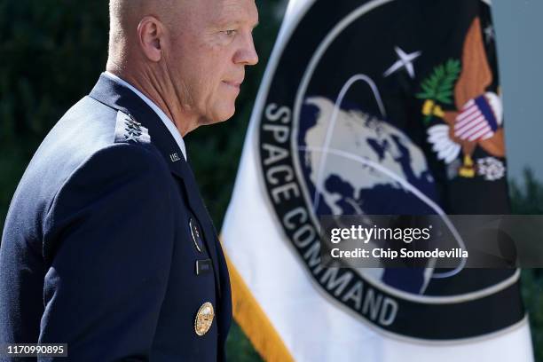 Air Force Space Command Gen. John "Jay" Raymond stands next to the flag of the newly established U.S. Space Command, the sixth national armed...