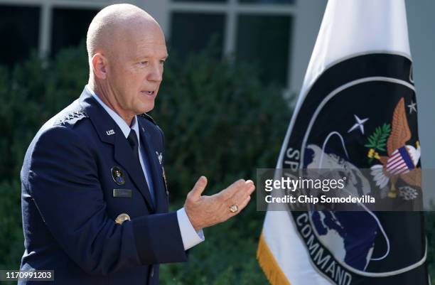 Air Force Space Command Gen. John "Jay" Raymond stands next to the flag of the newly established U.S. Space Command, the sixth national armed...