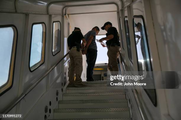 Guatemalan police prepare to escort a convicted criminal who arrived on an ICE deportation flight from Brownsville, Texas on August 29, 2019 to...