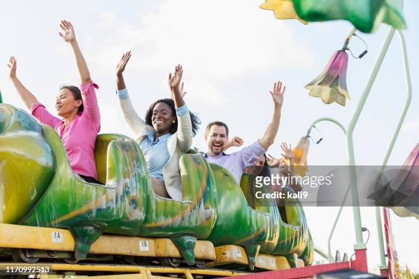 corporate team building on amusement park rollercoaster - young woman screaming on a rollercoaster stock pictures, royalty-free photos & images