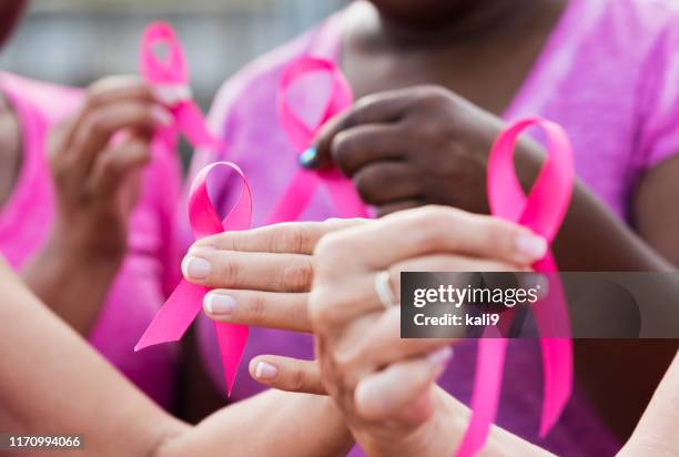 multi-ethnic women with breast cancer awareness ribbons - sensibilização para o cancro da mama imagens e fotografias de stock
