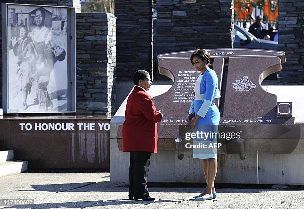 First Lady Michelle Obama talks with Antoinette Sithole, sister of Hector Pieterson, a 12-year-old boy killed during the student uprising in protest...