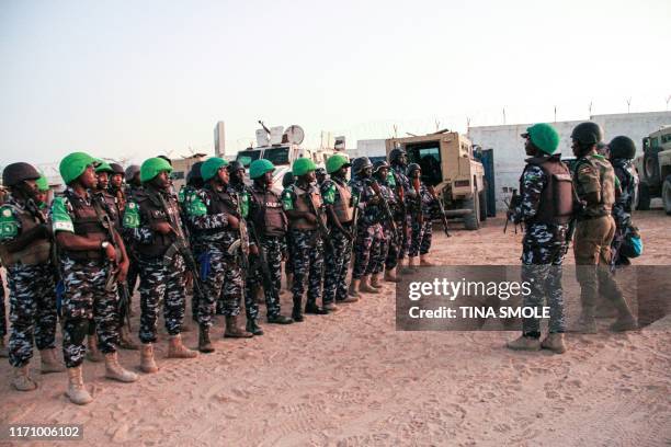 Police officers of the African Union's peacekeeping mission in Somalia from Uganda, Kenya, Sierra Leone, Nigeria, Ghana and Zambia gather before...