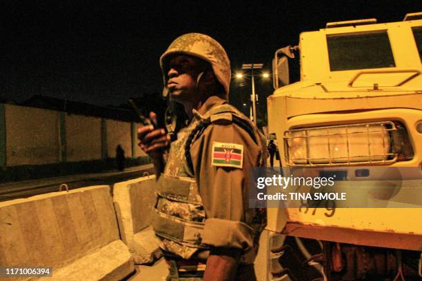 Kenyan police officer of the African Union's peacekeeping mission in Somalia takes part in a night patrol on a street in Mogadishu on September 17,...