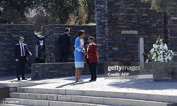 First Lady Michelle Obama talks with Antoinette Sithole, sister of Hector Pieterson, a 12-year-old boy killed during the student uprising in protest...