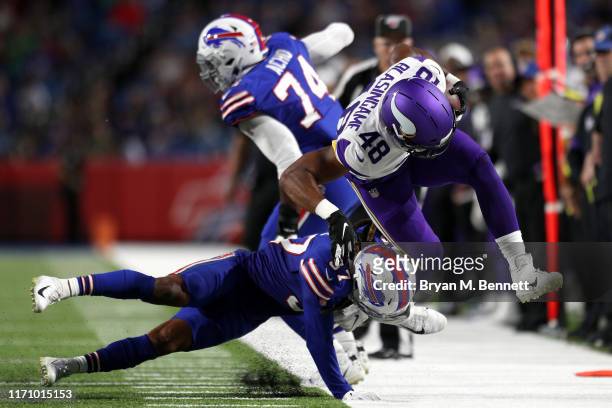 Khari Blasingame of the Minnesota Vikings is tackled by Denzel Rice of the Buffalo Bills during a preseason game at New Era Field on August 29, 2019...