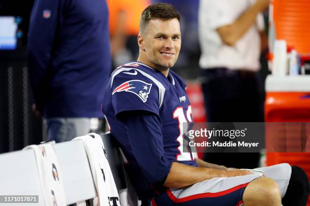 Tom Brady of the New England Patriots looks on from the bench during the preseason game between the New York Giants and the New England Patriots at...