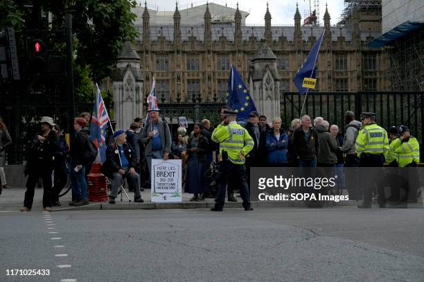 Anti Brexit protesters gather outside Parliament while holding EU and UK flags in London as the UK MPs get back to work.