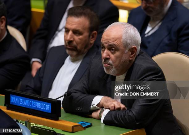 Iran's Foreign Minister Mohammad Javad Zarif listens as Iran's President Hassan Rouhani speaks at the 74th session of the United Nations General...