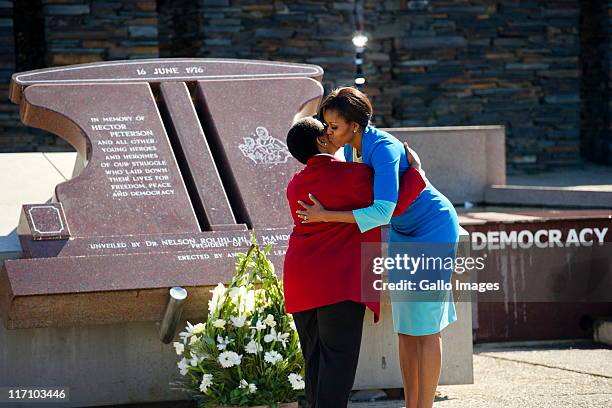 First Lady Michelle Obama and Hector Pieterson's sister Antoinette Sithole place a bouquet of flowers at the Hector Pieterson memorial site on June...