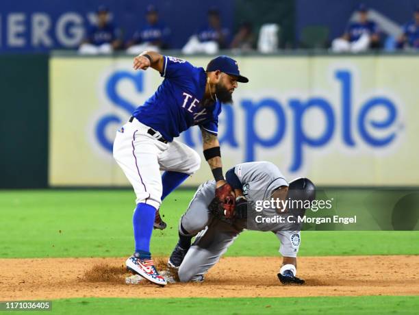 Rougned Odor of the Texas Rangers tags Keon Broxton of the Seattle Mariners at second base in the top of the eighth inning at Globe Life Park in...