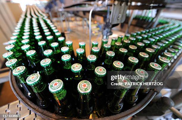 Bottles of beer are seen at the production line of Dutch brewer Heineken factory on June 7, 2011 in Schiltigheim, eastern France, during an official...