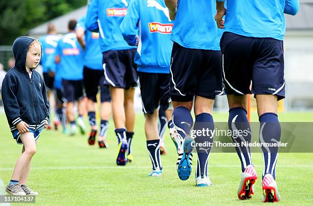 Supporter of TSG 1899 Hoffenheim watches the team warming up during a training session at the Dietmar-Hopp Stadion on June 22, 2011 in Hoffenheim,...