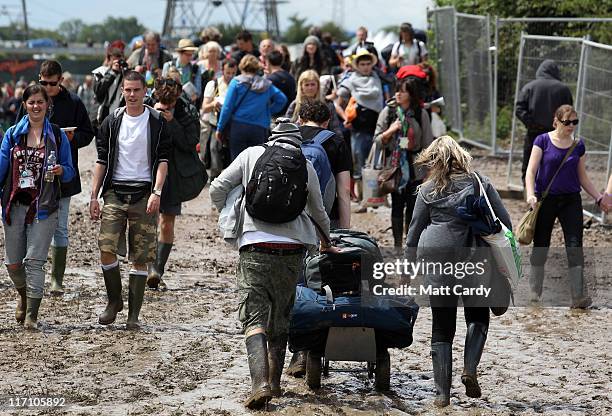 Festival attendees brave the mud as they arrive at the Glastonbury Festival site at Worthy Farm, Pilton on June 22, 2011 in Glastonbury, England....