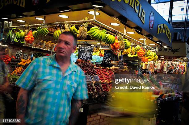 Customers walk passed a fruit and vegetables stand at the 'La Boqueria' fresh market on June 22, 2011 in Barcelona, Spain. Eurozone finance ministers...