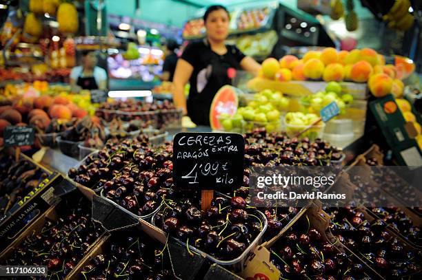 Sign shows the price in Euros for cherries at a fruit and vegetables stand at the 'La Boqueria' fresh market on June 22, 2011 in Barcelona, Spain....