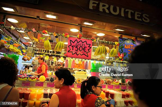 Sign shows the price in Euros for fresh fruit juices at a fruits stand at the 'La Boqueria' fresh market on June 22, 2011 in Barcelona, Spain....