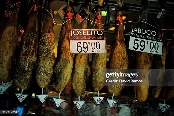 Signs show the prices in Euros for ham at a butcher stand at the 'La Boqueria' fresh market on June 22, 2011 in Barcelona, Spain. Eurozone finance...