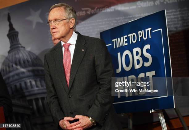 Senate Majority Leader Harry Reid listens as other senators speak during a press conference on job creation at the U.S. Capitol on June 22, 2011 in...