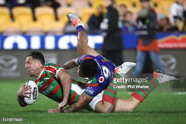Sam Burgess of the Rabbitohs is tackled by Issac Luke of the Warriors during the round 24 NRL match between the New Zealand Warriors and the South...