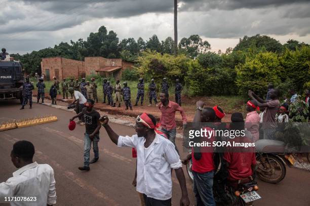 Supporters of Bobi Wine face down with police in Hoima. Wine aka Robert Kyagulanyi, campaigned in Hoima ahead of a by-election. It was the first time...