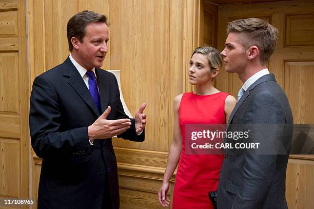 British Prime Minister David Cameron talks with Hollyoaks actors Victoria Atkin and Kieron Richardson at a reception in Downing Street, central...