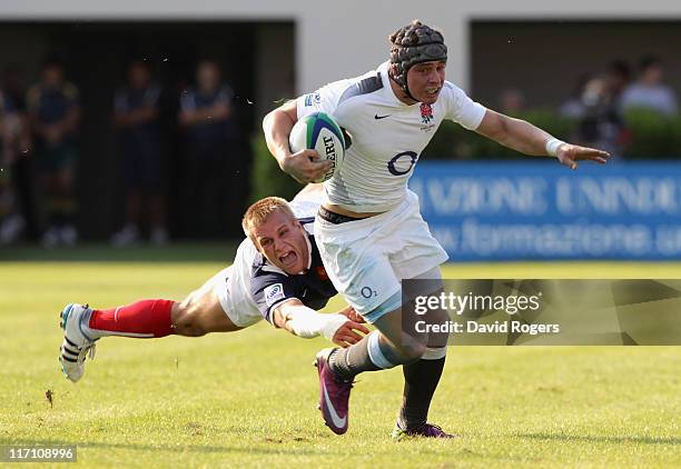 Ben Ransom of England moves away from Marvin O'Connor of France during the IRB Junior World Championship match between England and France at the...