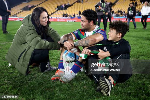 Prime Minister Jacinda Ardern stops to talke with Issac Luke of the Warriors who sits with his son Adaquix following the round 24 NRL match between...
