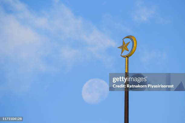 photograph symbol of islam with a moon and cloud with sunrise light - islam symbol stock pictures, royalty-free photos & images