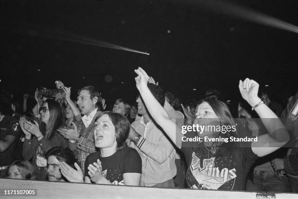 Fans attend Paul McCartney and the Wings' concert at the Hammersmith Odeon during their 'Wings Over the World tour', London, UK, 18th October 1976.