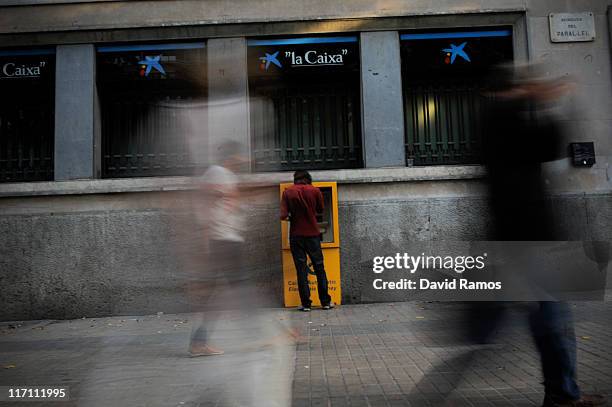 Man withdraws money from a chashpoint at a bank on June 22, 2011 in Barcelona, Spain. Eurozone finance ministers are currently seeking to find a...