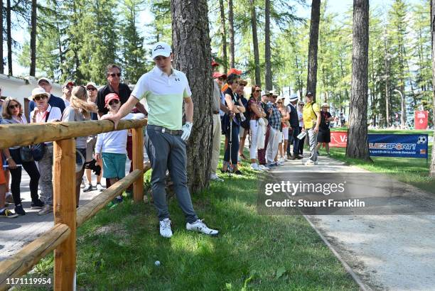 Defending Champion Matt Fitzpatrick of England looks at his options to play a shot from behind a fence on the sixth hole during Day two of the Omega...