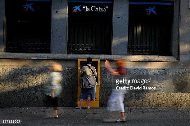 Woman withdraws money from a chashpoint at a bank on June 22, 2011 in Barcelona, Spain. Eurozone finance ministers are currently seeking to find a...