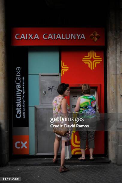 People withdraw money from a chashpoint at a bank on June 22, 2011 in Barcelona, Spain. Eurozone finance ministers are currently seeking to find a...