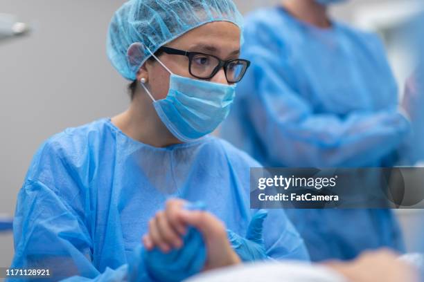 doctor holding patient's hand before surgery - mid wife stock pictures, royalty-free photos & images