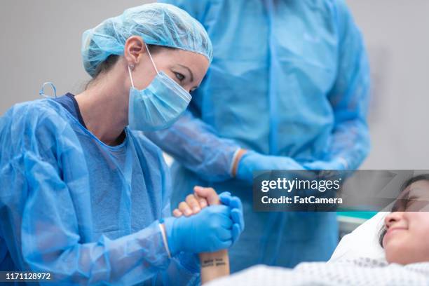 médico que sostiene la mano del paciente antes de la cirugía - comadrona fotografías e imágenes de stock