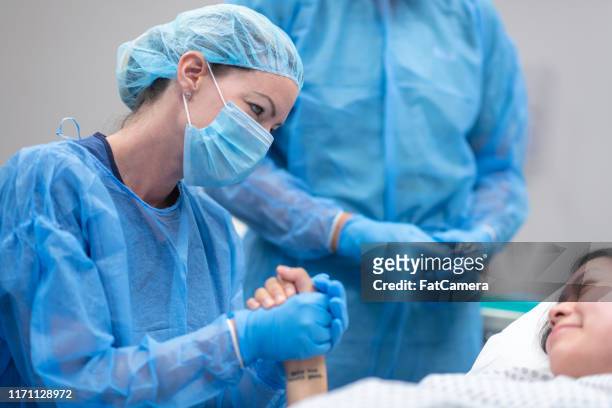 doctor holding patient's hand before surgery - obstetrician stock pictures, royalty-free photos & images