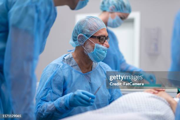 doctor with team of surgeons prepares to perform cesarean section surgical operation - doctor scrubs stock pictures, royalty-free photos & images