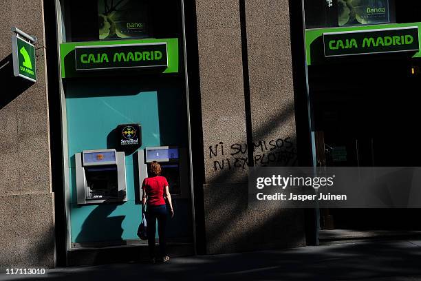 Woman uses a cash machine on June 22, 2011 in Madrid, Spain. Eurozone finance ministers are currently seeking to find a solution to Greece's pressing...